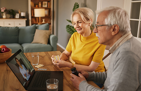 Senior couple using telemedicine for an online doctor consultation at home convenient elderly care services
