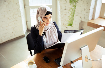 Medical professional handling a doctor on call consultation through phone and computer