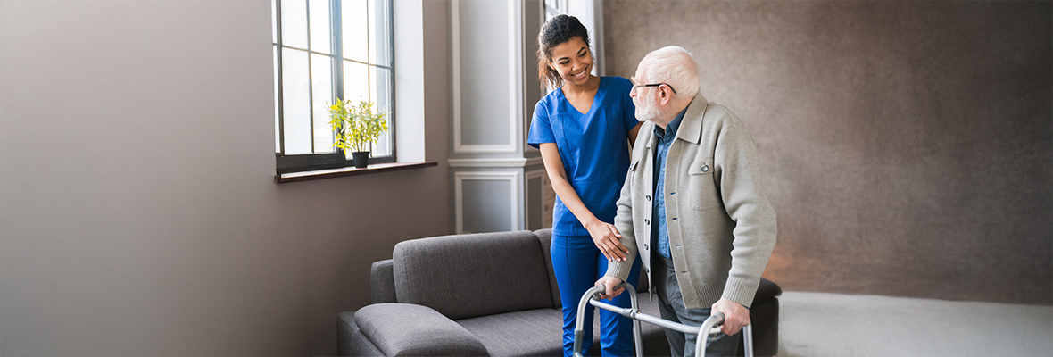 nurse assisting elderly patient with walker desktop