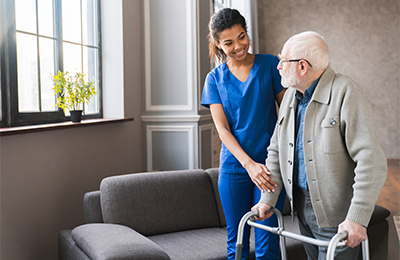 nurse assisting elderly patient with walker mobile